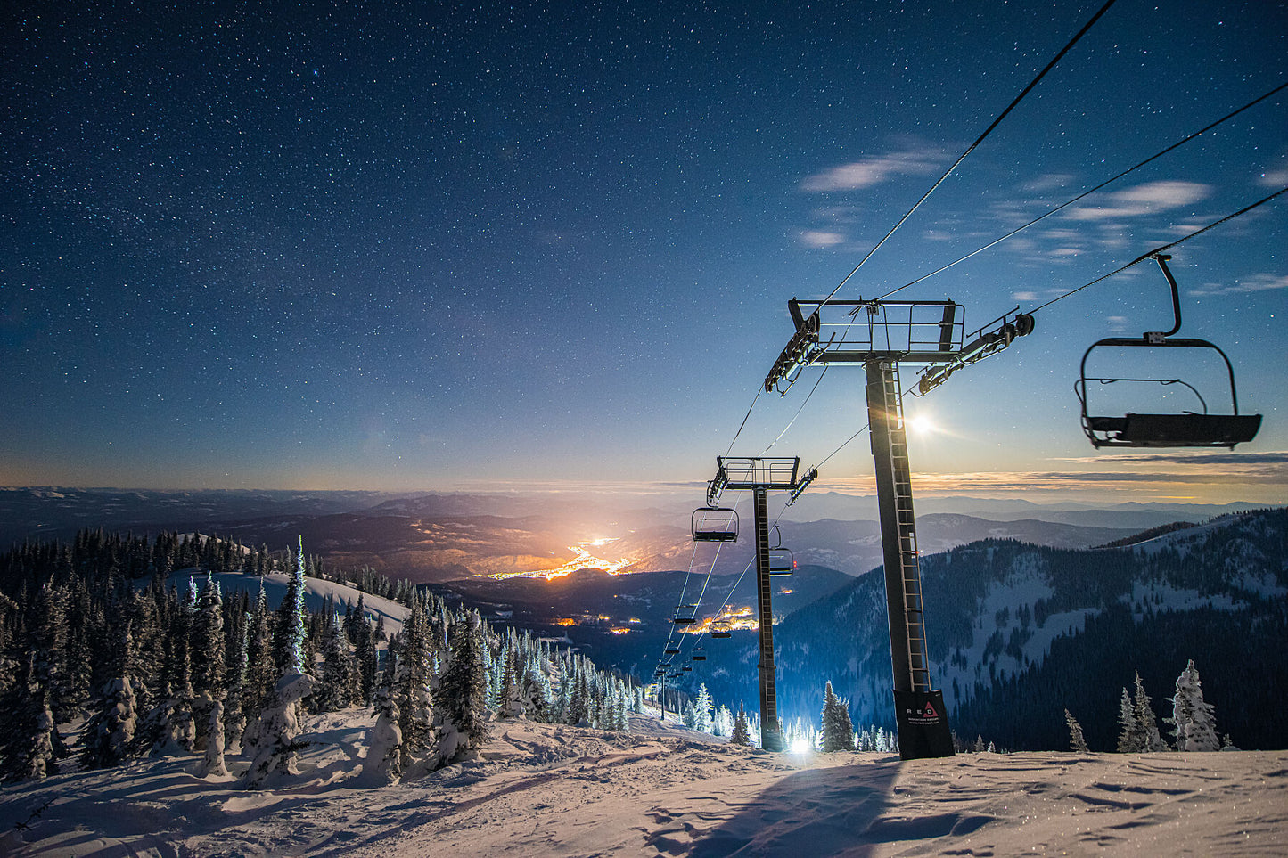 Night view of the Grey Chair and the distant lights of Trail, at RED Mountain Resort. West Kootenay fine art photography by Ashley Voykin