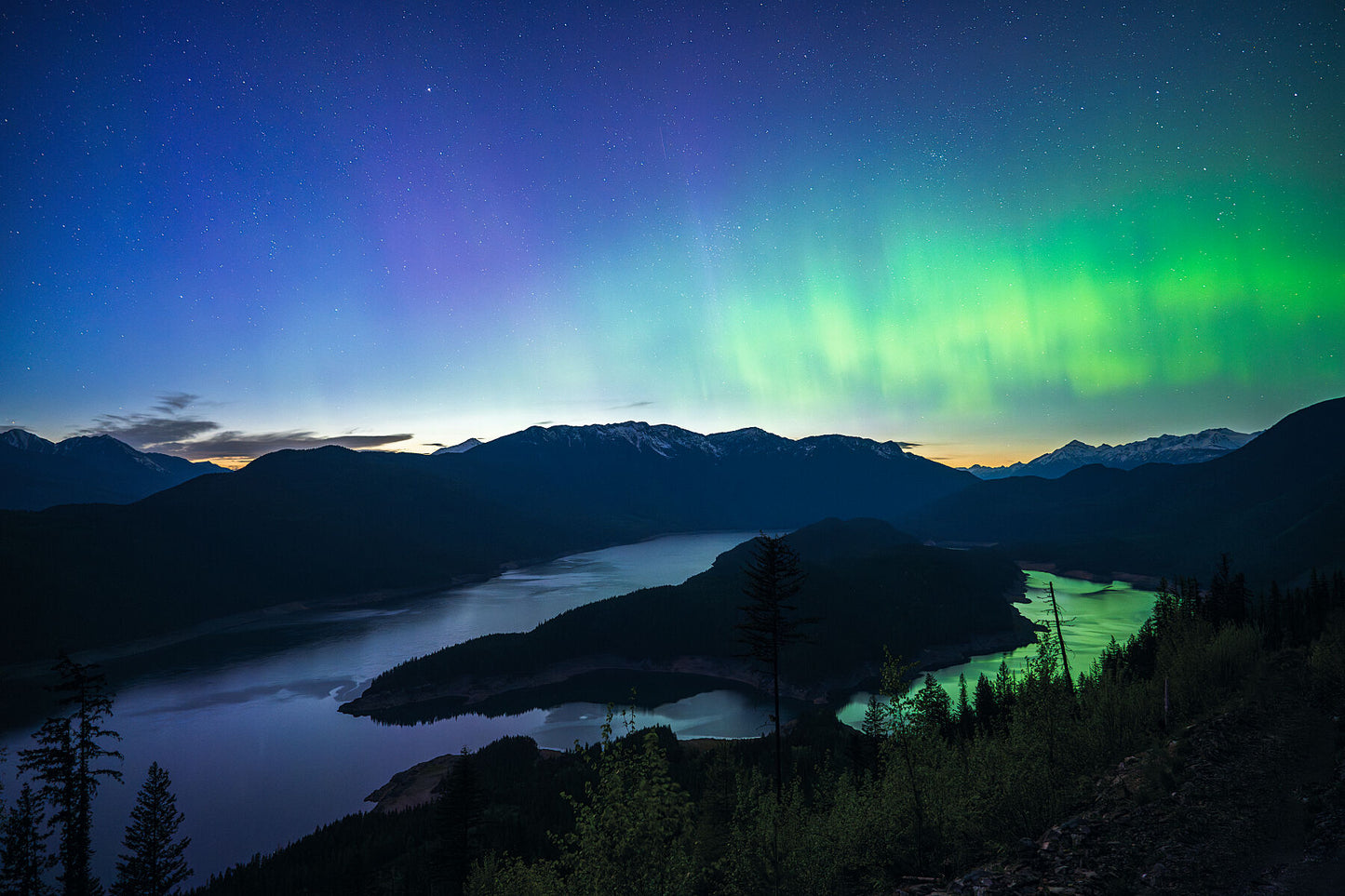 Northern Lights dancing over Duncan Island and Duncan Lake in the West Kootenay Region of British Columbia, astrophotography by Ashley Voykin