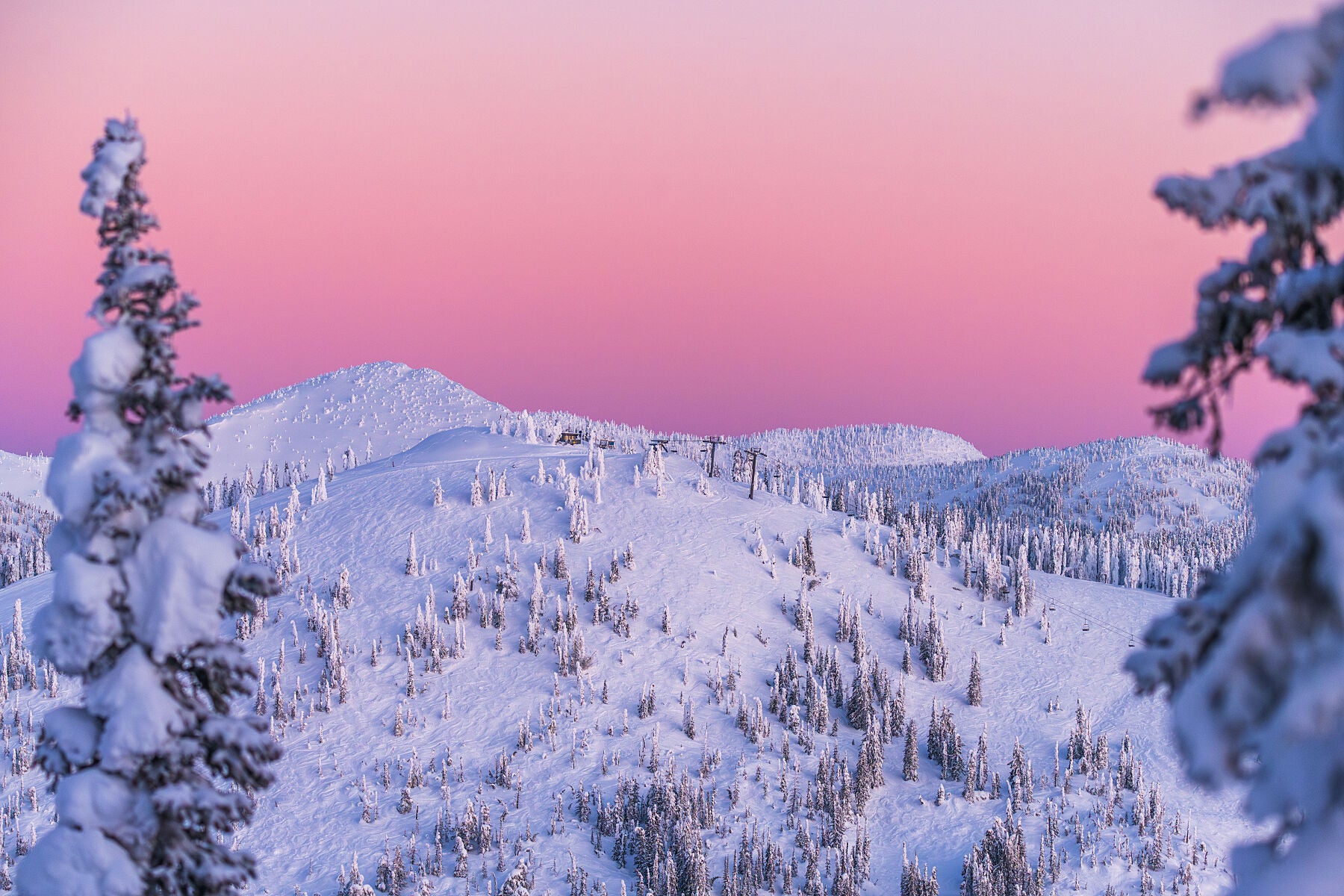 A scenic view of a sunrise light on a snow-covered Grey Mountain at RED Mountain Resort, fine art limited edition print by West Kootenay Photographer Ashley Voykin