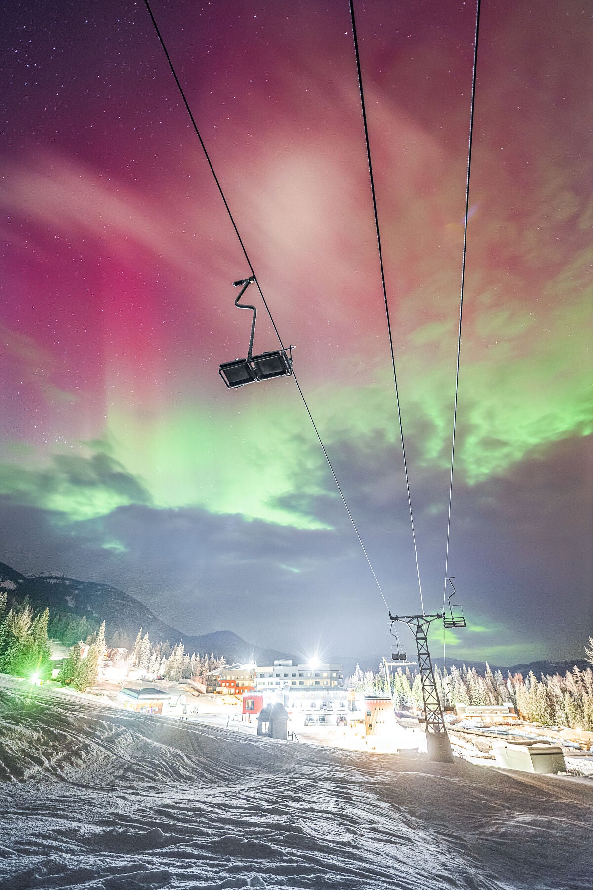 Aurora Borealis dancing over RED Mountain Resort in the Winter, fine art photography print by Ashley Voykin