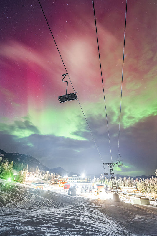 Aurora Borealis dancing over RED Mountain Resort in the Winter, fine art photography print by Ashley Voykin