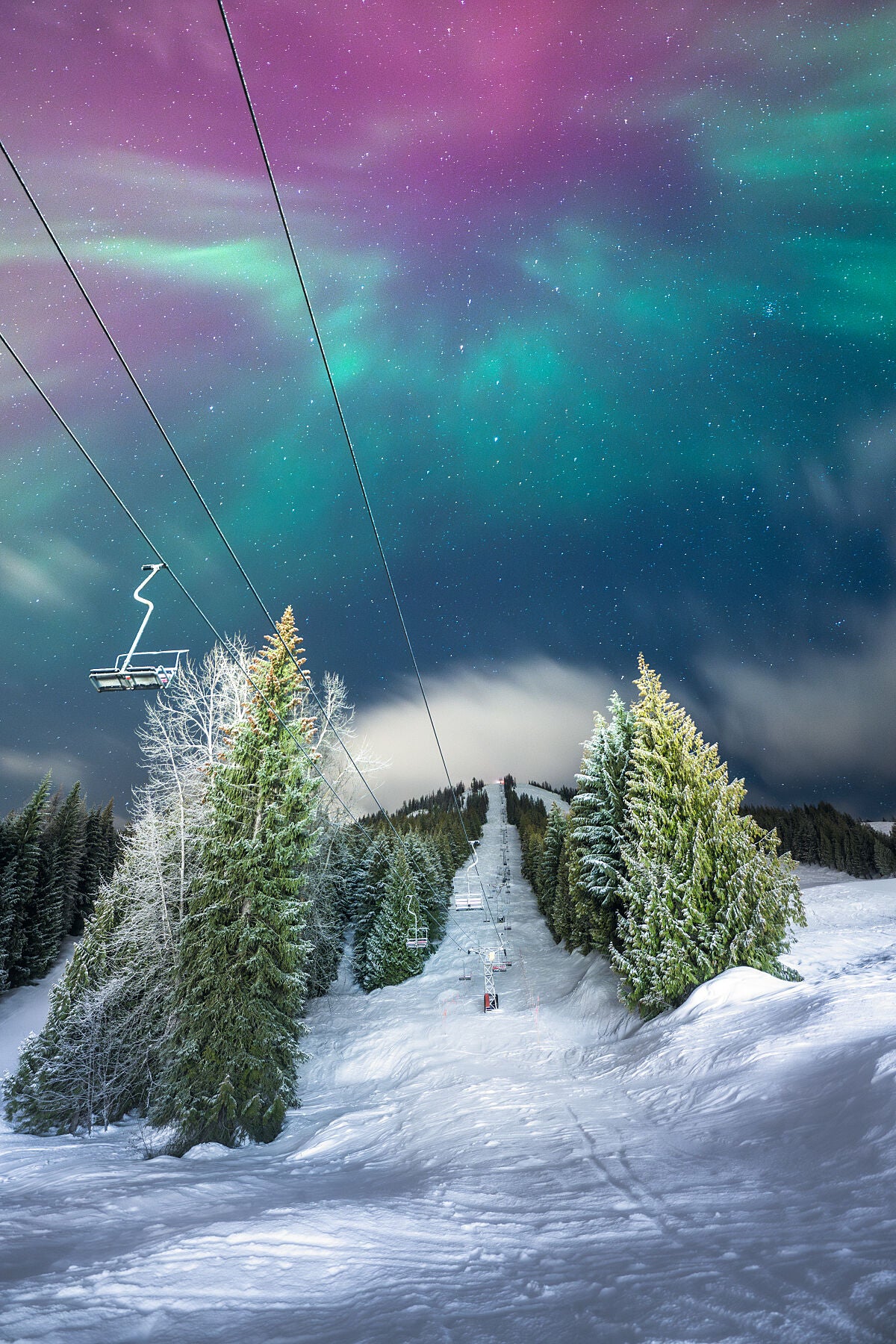 Aurora Borealis dancing over the historic Red Chair at RED Mountain Resort in Rossland, fine art landscape photography by Ashley Voykin