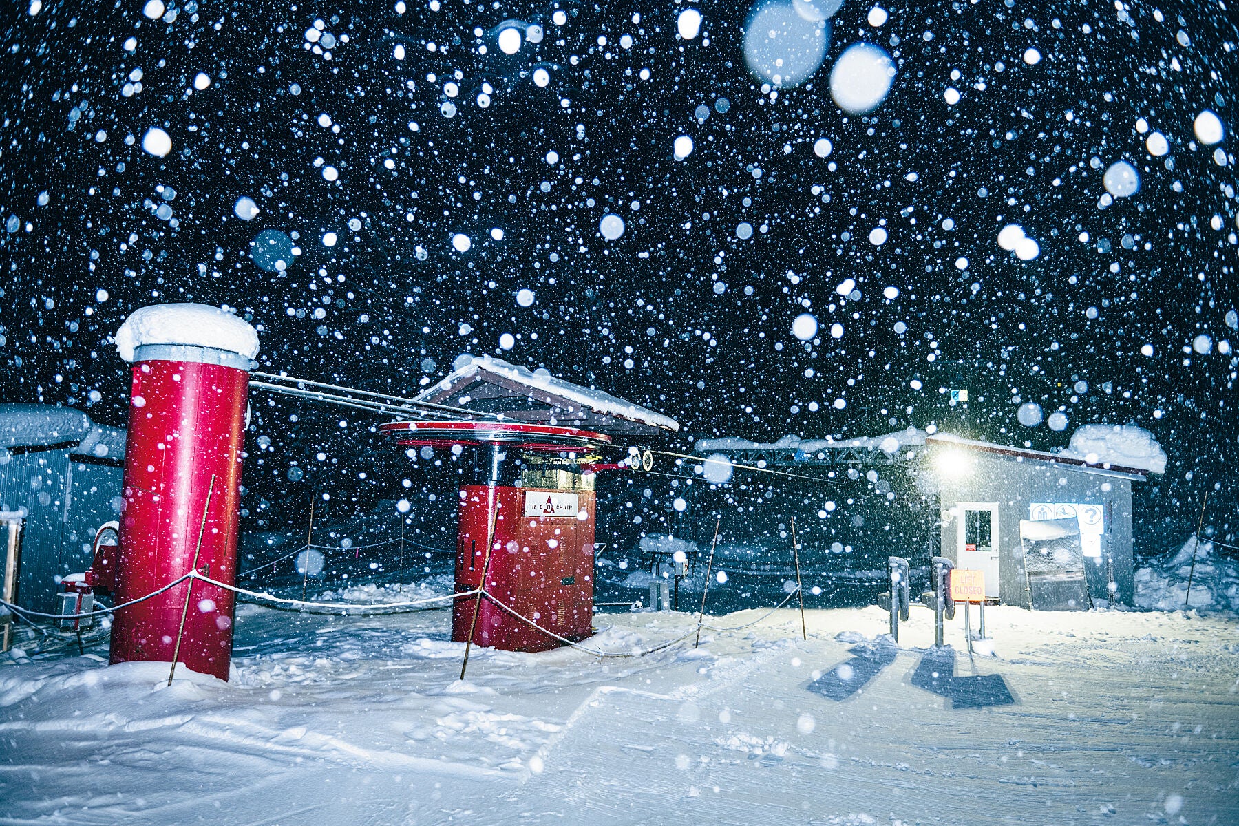 Heavy snow falling over the Red Chair at RED Mountain Resort in Rossland, fine art landscape print by Ashley Voykin