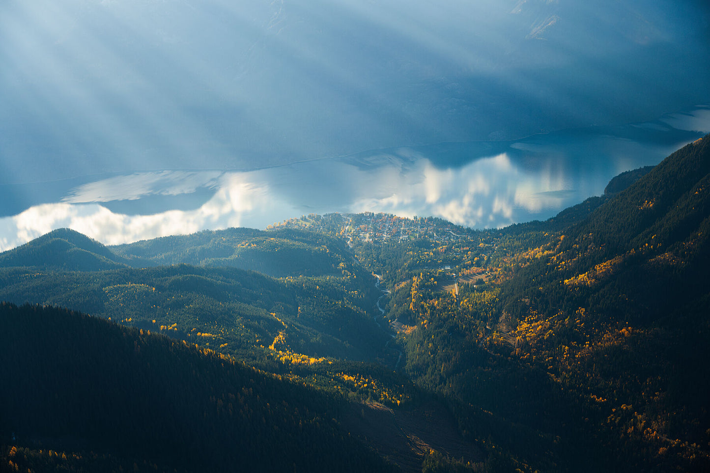 An aerial view of New Denver, British Columbia, with mountains and Slocan Lake, fine art landscape print from British Columbia’s West Kootenay region by Ashley Voykin