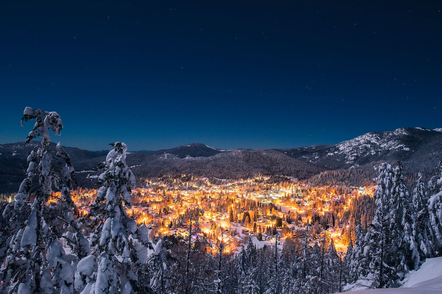 A nighttime view of Rossland British Columbia, lit by the city lights and moonlight, West Kootenay fine art landscape photography by Ashley Voykin
