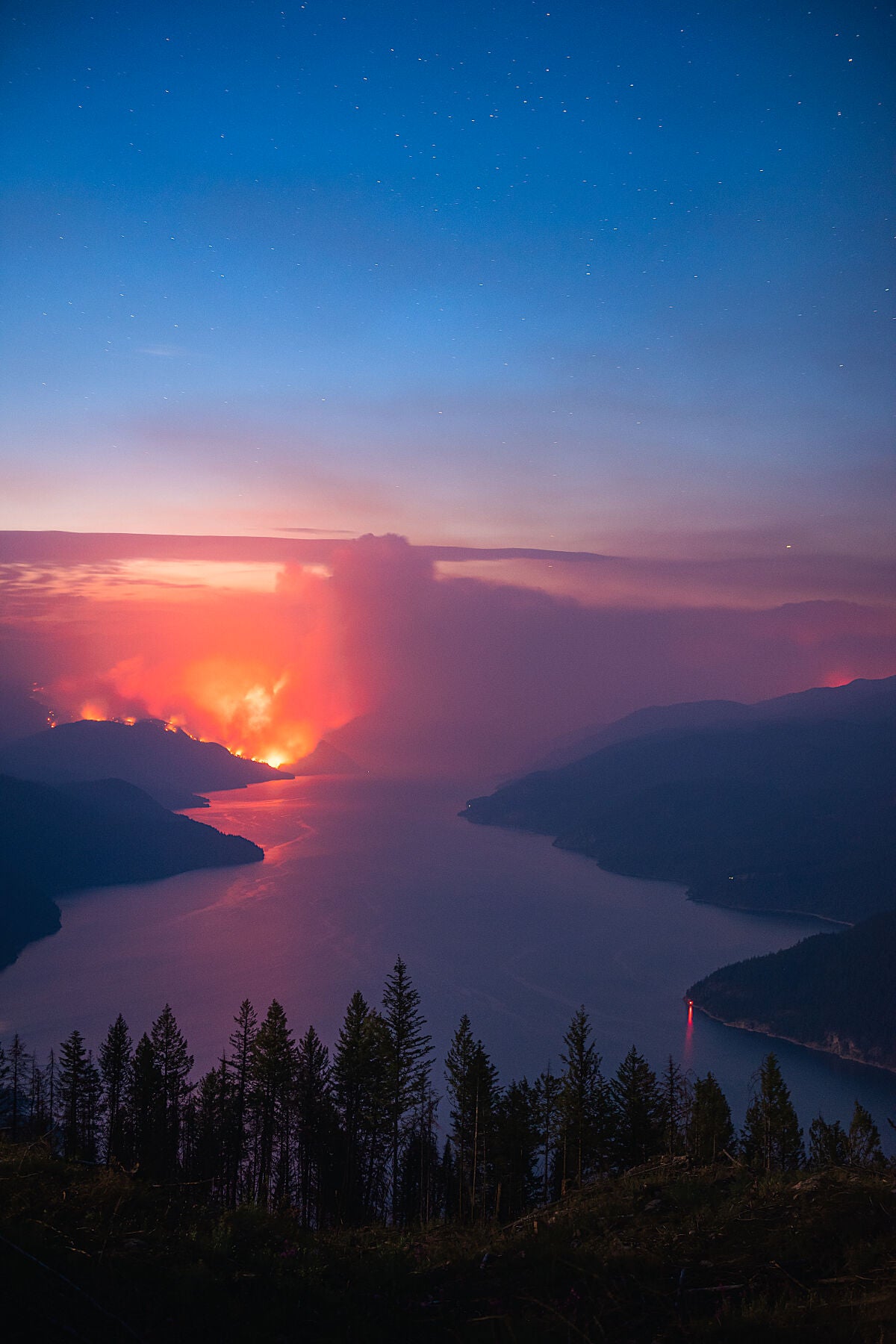 The Michaud Creek Wildfire burning on the West Shore of Lower Arrow Lake, while the Octopus Creek wildfire burns to the East. Environmental fire photography by Ashley Voykin.