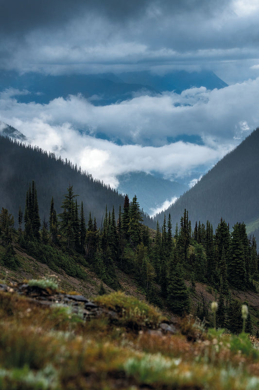 A cloudy day in the Goat Range, looking out towards the Purcell Mountains, landscape photography by West Kootenay based Ashley Voykin.