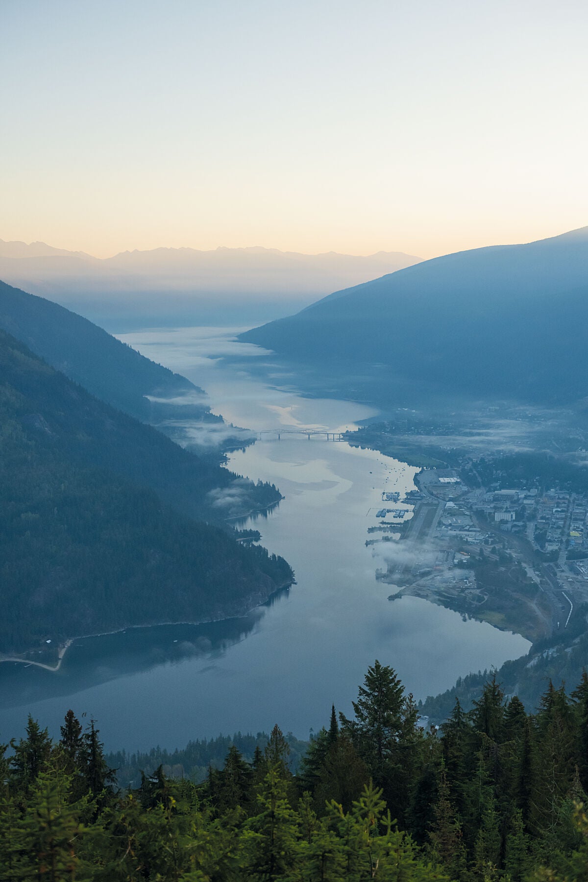 Sunrise illuminating the mountains surrounding Nelson, British Columbia on a summer morning, Kootenay fine art photography by Ashley Voykin