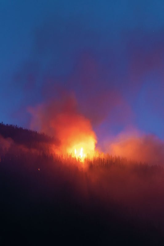 A photo showing the Talbot Creek wildfire in Slocan Valley, BC, during evening light. Environment photography by Ashley Voykin.