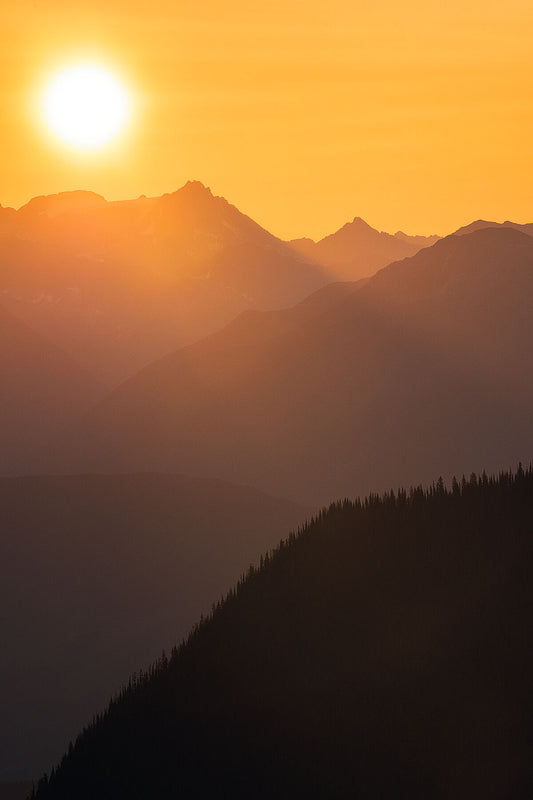 Sunrise light over the peaks of the Purcell Mountain range, landscape photography by Ashley Voykin.