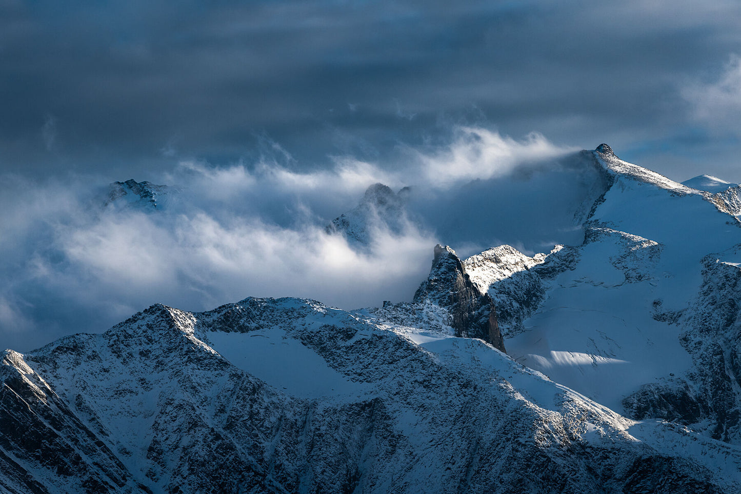 Fresh snow on the mountain peaks of the Purcell Mountain Range, in British Columbia's West Kootenay Region. West Kootenay fine art photography by Ashley Voykin
